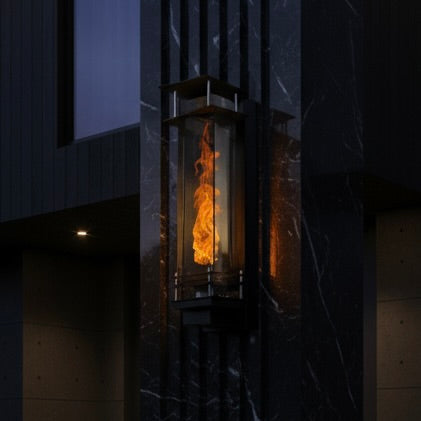Vortex fire torches lt up at night mounted on a pool waterfall