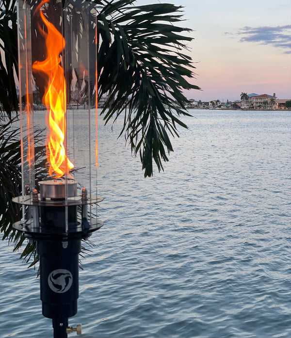 Vortek The Ultimate Tiki Torch with beautiful spiraling flame at sunset against an intercoastal background