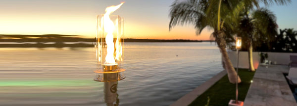 Vortek The Ultimate Tiki Torch with beautiful spiraling flame at sunset against an intercoastal background