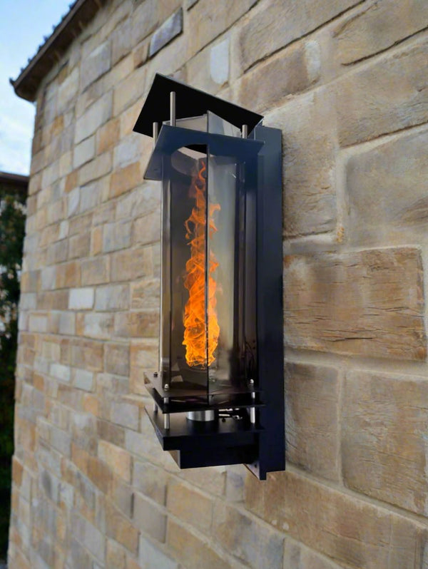 Vortex fire torches lt up at night mounted on a pool waterfall