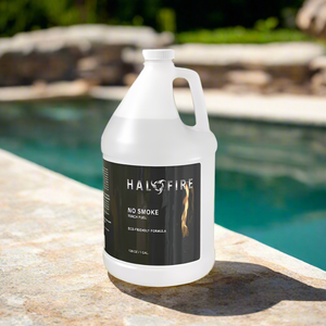 Gallon container of Halo Fire ClearFire - Smoke Free torch fuel on a stone ledge by a pool.