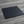 Black rectangular object on a wooden surface