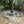Concrete fire pit with stone patio and trees in the background