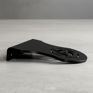 Black metal bracket on a gray surface with a neutral background