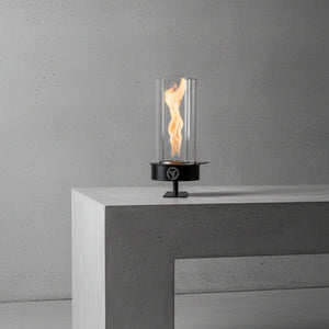 Modern outdoor fire pit on a concrete surface with a gray background