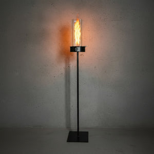 Modern floor lamp with a glass cover and black base on a gray background