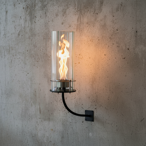 Wall-mounted fire lantern with flames on a concrete wall