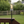 Outdoor fire torch on a deck with a blurred garden background