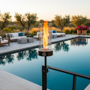 Fire pit by a pool with outdoor furniture and sunset in the background