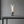 Modern table lamp with flame effect on a gray surface and background