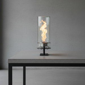 Modern table lamp with flame effect on a gray surface and background