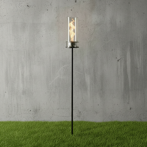 Torch-style outdoor light on a grassy area with a concrete wall background