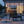 Outdoor patio scene with a lit fire pit and modern furniture at dusk.