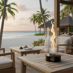 Outdoor patio with fire pit, table, and chairs by the beach with palm trees.