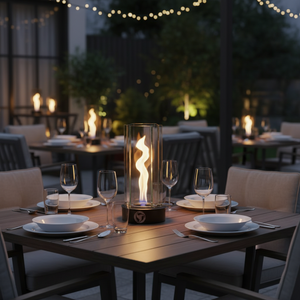 Dining table set with plates, glasses, and a lit fire pit in an outdoor setting.