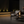 Modern table lamp with glass shade and visible flame on a neutral background