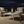 Modern table lamp with glass shade and visible flame on a neutral background