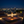 Modern table lamp with glass shade and visible flame on a neutral background