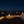 Modern table lamp with glass shade and visible flame on a neutral background