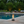 Modern table lamp with glass shade and visible flame on a neutral background 