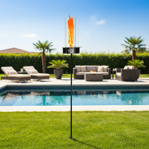 Outdoor fire pit with decorative flag by a poolside
