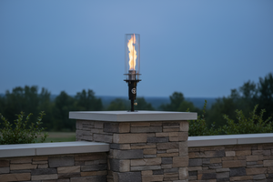 Hollywood Series Vortek post mount fire feature designed for column and post installations, featuring a tall vortex flame and clear glass wind guard for luxury outdoor patios and commercial landscapes