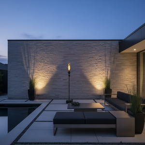 Outdoor gas tiki torch featuring a tall vertical flame, clear glass wind guard, and black metal base for modern patio, garden, and landscape lighting using propane or natural gas.