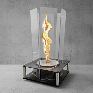 Modern table-top fireplace with glass enclosure and flame on a concrete floor.