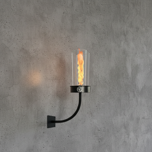 Wall-mounted firelamp with flame on a concrete wall