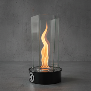 Modern glass table top fireplace with flames on a concrete floor and gray wall background