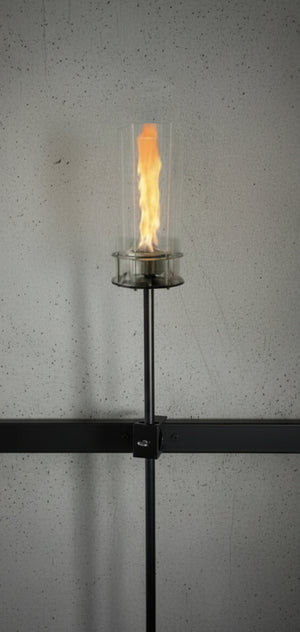 Modern wall-mounted light fixture with a glass cover on a gray wall.