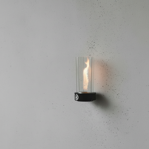 Wall-mounted vortex torch on a bracket holder with a lit flame on a gray wall