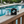Metal bracket on a wooden deck with a pool in the background
