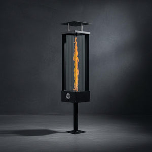 Tall outdoor fire pit with flames on a dark background