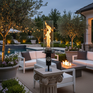 Outdoor patio with fire pit, table, and chairs in a garden setting.