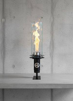Modern outdoor torch with flames on a concrete surface and wall background
