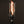 Fire torch with a black base and clear glass container on a dark background