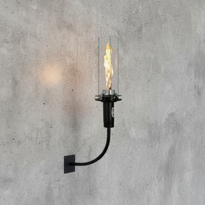 Wall-mounted candle-style light fixture on a concrete wall