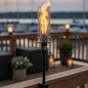 Fire torch on a wooden deck with a waterfront view
