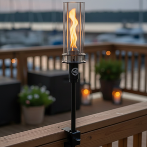 Outdoor patio torch with flame on a wooden deck