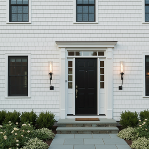 Front door of a house with white walls and black door