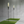 Two torches on grass mats in a room with concrete walls.