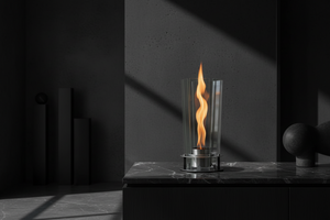 Modern outdoor fireplace with flames on a concrete surface and gray background