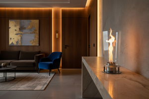 Modern outdoor fireplace with flames on a concrete surface and gray background