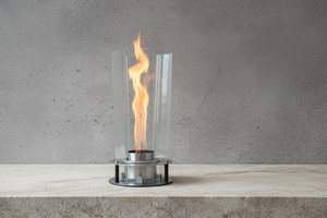 Modern outdoor fireplace with flames on a concrete surface and gray background