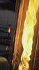 Modern outdoor fire torches burning at sunset on a patio, featuring clean flame technology and luxury design for backyard ambiance, outdoor entertaining, and modern landscape lighting.