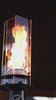 Slow-motion close-up of a modern outdoor gas torch emitting swirling blue and orange flames, showcasing clean-burning fuel ignition, smooth flame motion, and high-heat performance in a sleek metal torch design for patio, backyard, and outdoor ambiance