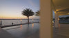 Modern outdoor fire torches burning at sunset on a patio, featuring clean flame technology and luxury design for backyard ambiance, outdoor entertaining, and modern landscape lighting.