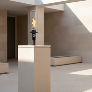 Post mounted vortex fire torch for column and pillar installations, featuring a tall vortex flame, clear glass wind guard, and black powder-coated body, compatible with natural gas or propane for luxury outdoor patios and commercial landscapes