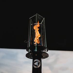 Flickering flame inside a glass container on a black background